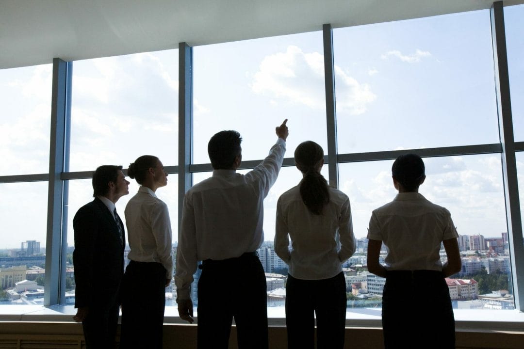 Corporate people looking out a window